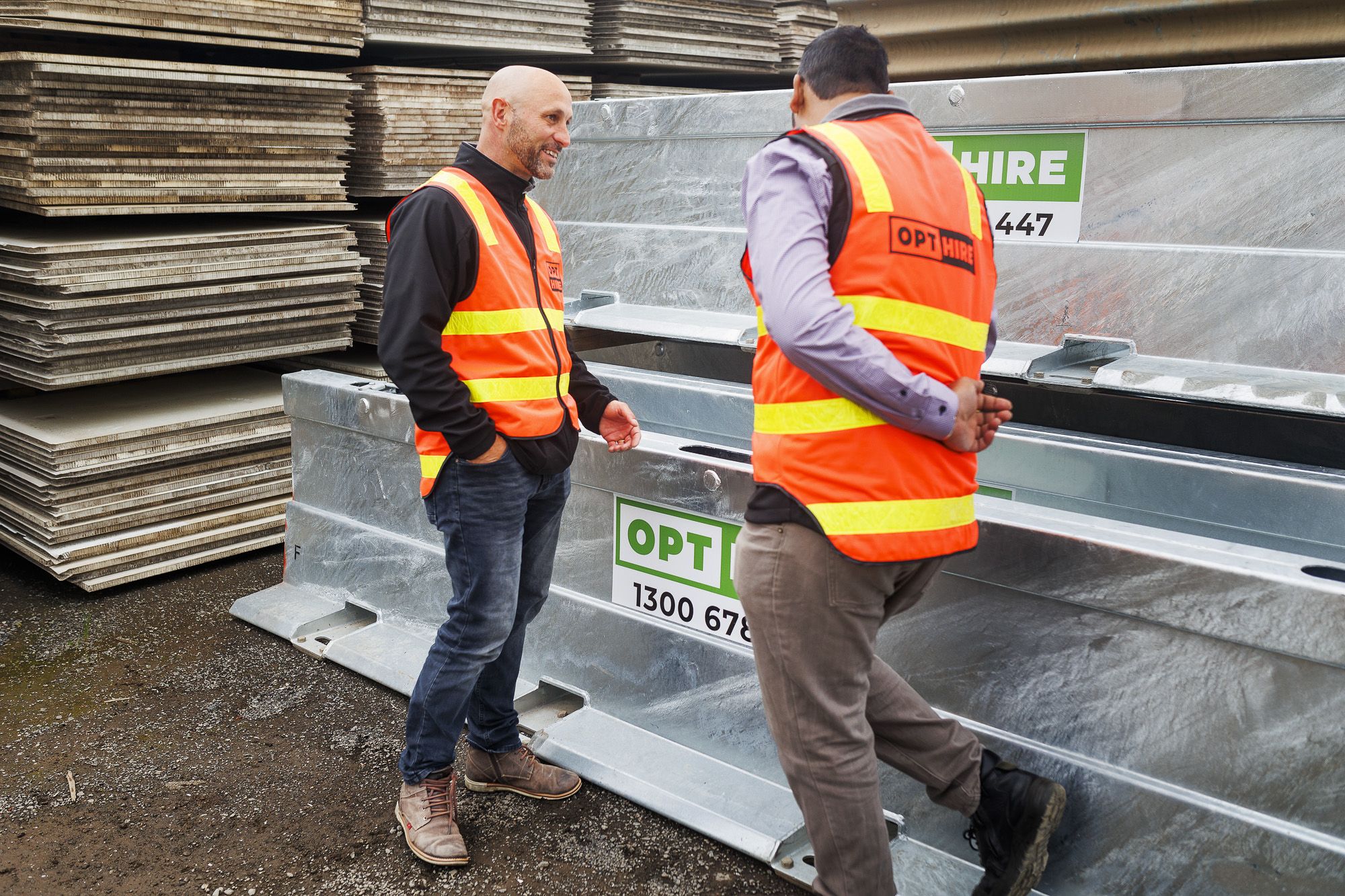 men discussing in front of barriers