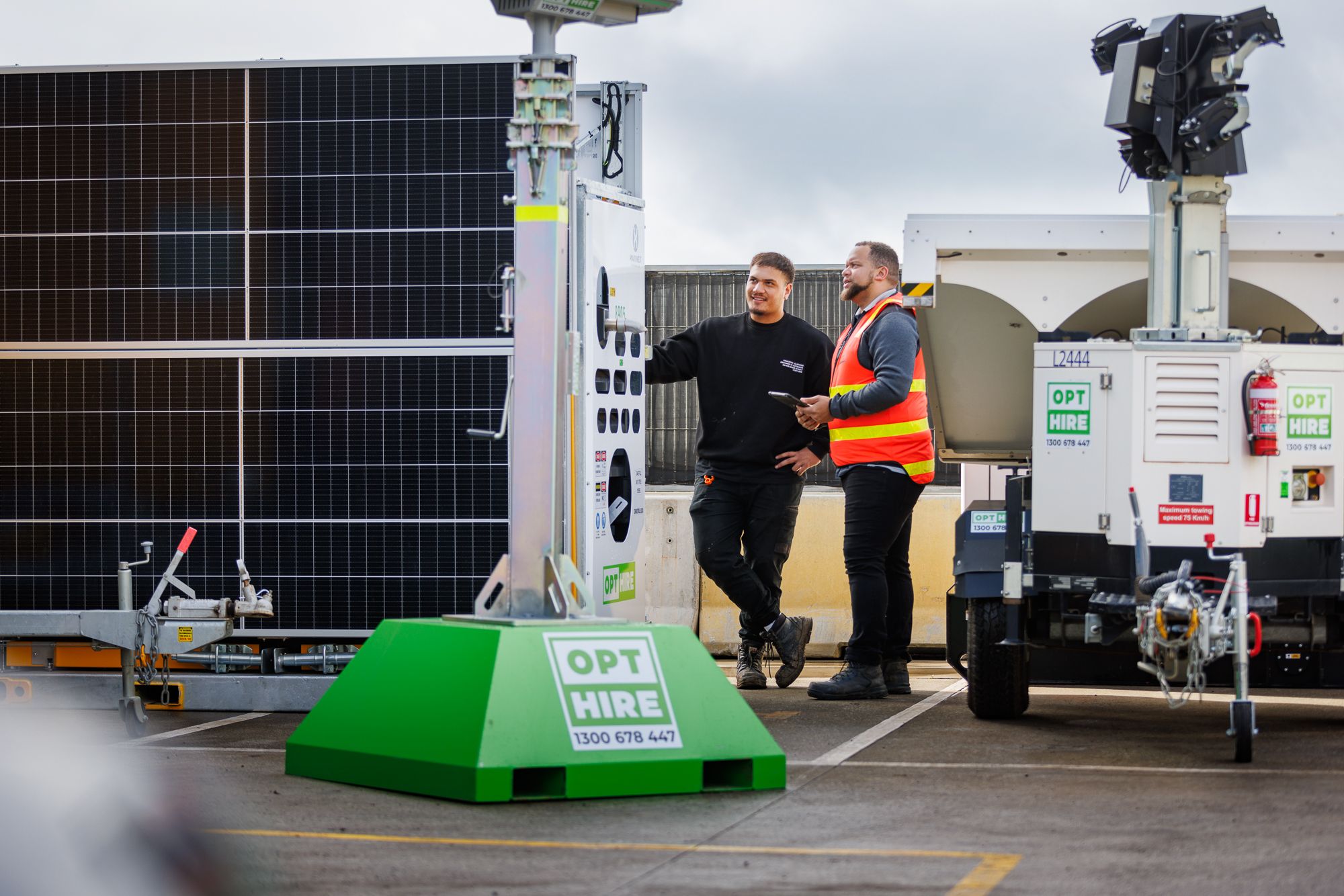 2 men standing in front of tower